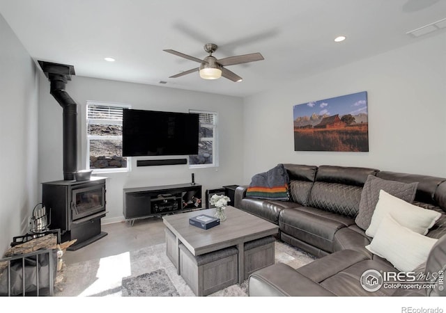 609 Hummer Dr, Nederland, CO 80466 - living area featuring concrete floors, a wood stove, ceiling fan, and recessed lighting