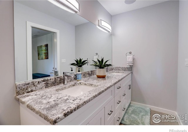 609 Hummer Dr, Nederland, CO 80466 - bathroom with double vanity, baseboards, and a sink
