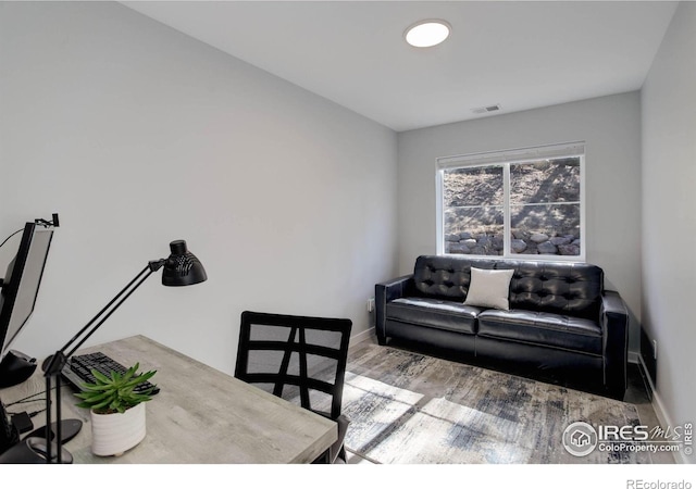 609 Hummer Dr, Nederland, CO 80466 - living area with visible vents, baseboards, and wood finished floors