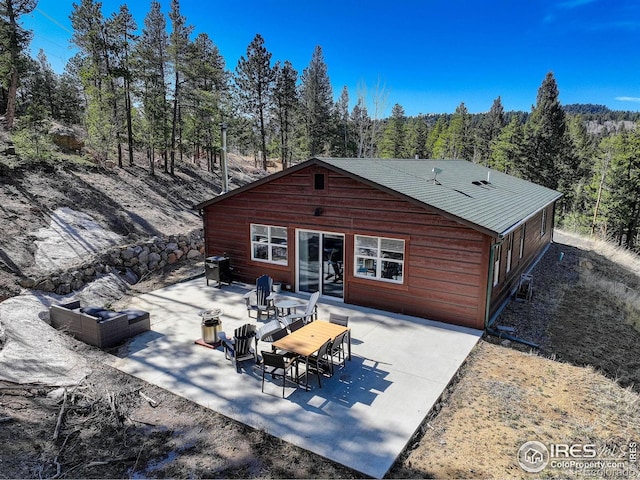 609 Hummer Dr, Nederland, CO 80466 - back of property featuring a view of trees and a patio area