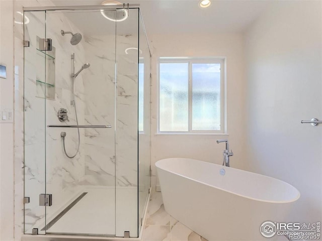 bathroom featuring a soaking tub, a marble finish shower, and recessed lighting