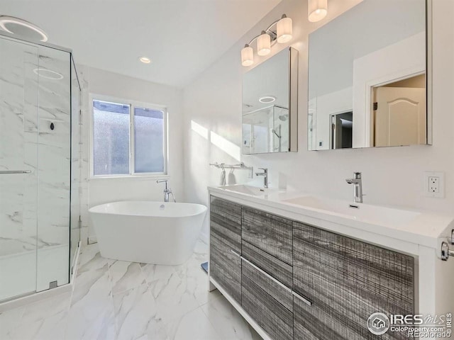 full bath featuring a marble finish shower, a freestanding tub, double vanity, and marble finish floors