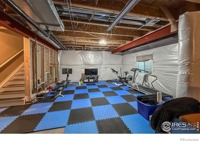 below grade area featuring tile patterned floors and stairway
