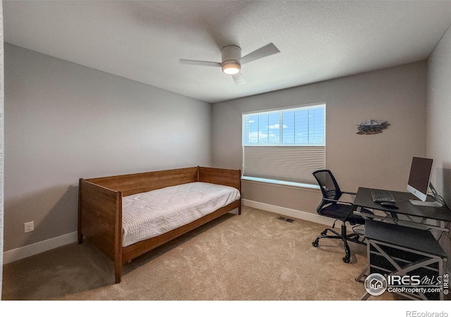 bedroom with an office area, baseboards, carpet floors, and ceiling fan