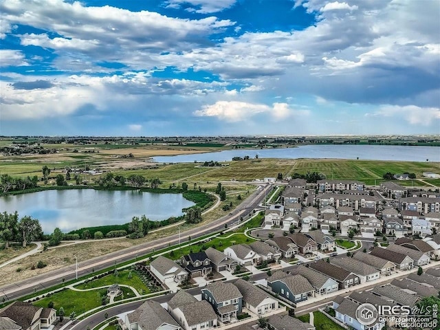 aerial perspective of suburban area featuring a nearby body of water