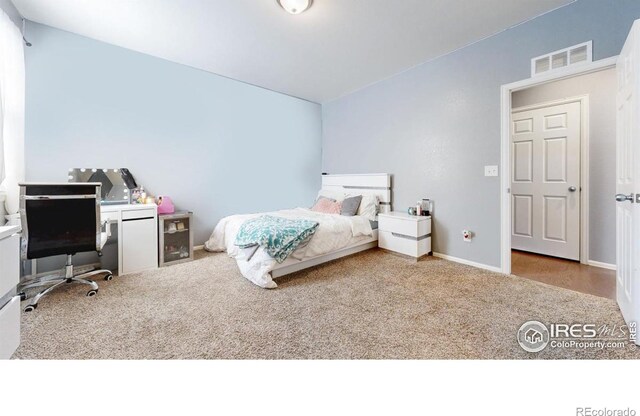 bedroom featuring carpet flooring, an office area, and baseboards