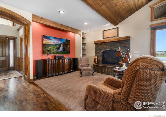 living area featuring a stone fireplace, baseboards, recessed lighting, lofted ceiling, and wood finished floors