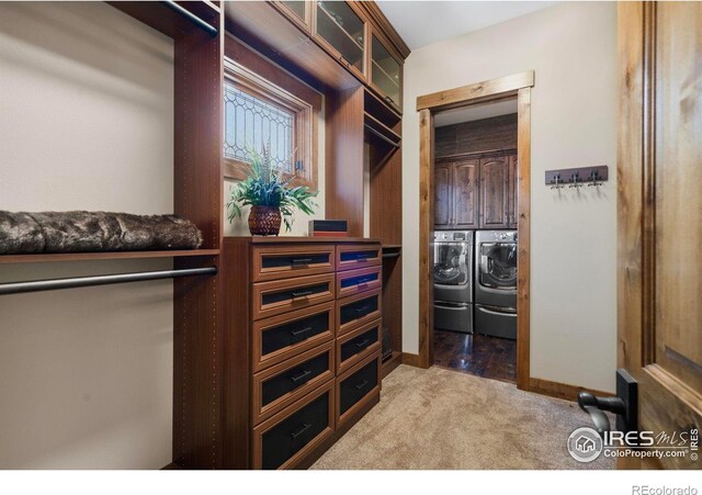 walk in closet featuring carpet flooring and washer and dryer