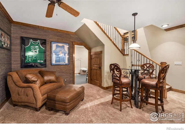 interior space with stairway, baseboards, a ceiling fan, and ornamental molding