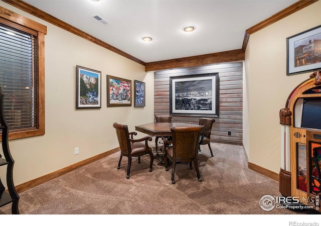 dining area featuring crown molding, baseboards, visible vents, and carpet floors