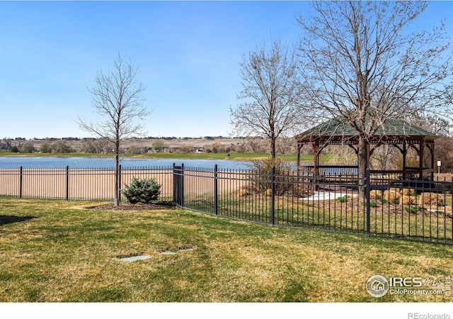 view of yard with a water view, a gazebo, and fence