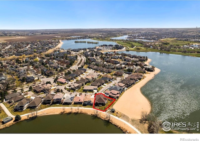 drone / aerial view with a residential view and a water view