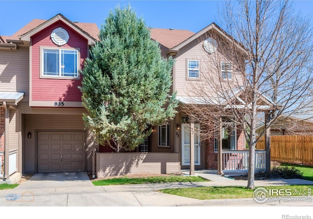 835 Kane Dr Unit 27, Longmont, CO 80501 - multi unit property featuring a garage, a porch, fence, and concrete driveway
