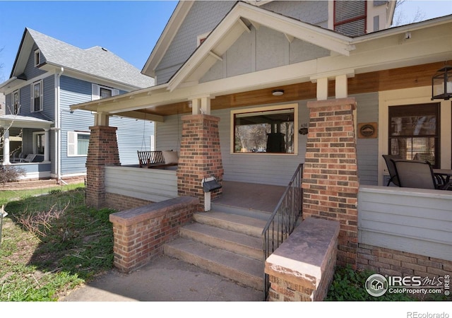 doorway to property featuring covered porch