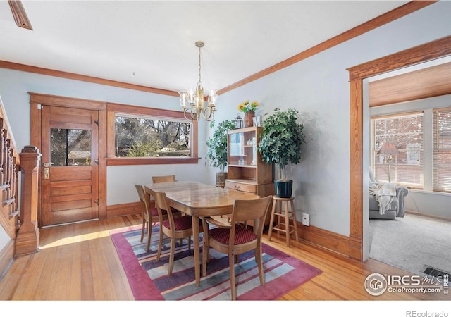 dining room with baseboards, a chandelier, and hardwood / wood-style flooring