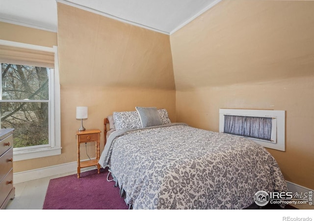 bedroom with crown molding and baseboards