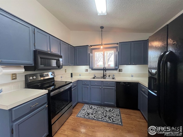 1406 Oak Dr, Berthoud, CO 80513 - kitchen featuring a textured ceiling, a sink, black appliances, and blue cabinetry