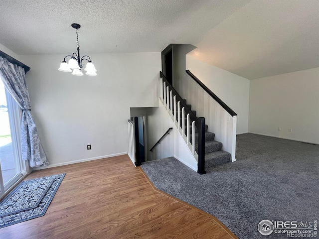 1406 Oak Dr, Berthoud, CO 80513 - interior space with a wealth of natural light, a textured ceiling, a chandelier, and wood finished floors