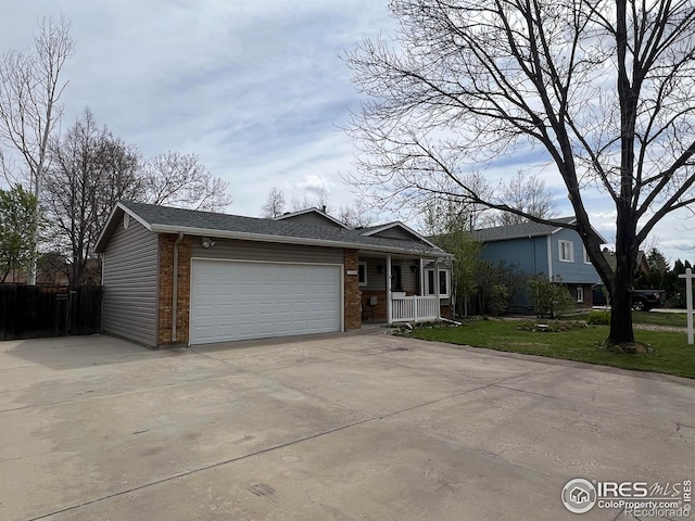 1406 Oak Dr, Berthoud, CO 80513 - ranch-style house with a porch, a front yard, brick siding, an attached garage, and concrete driveway