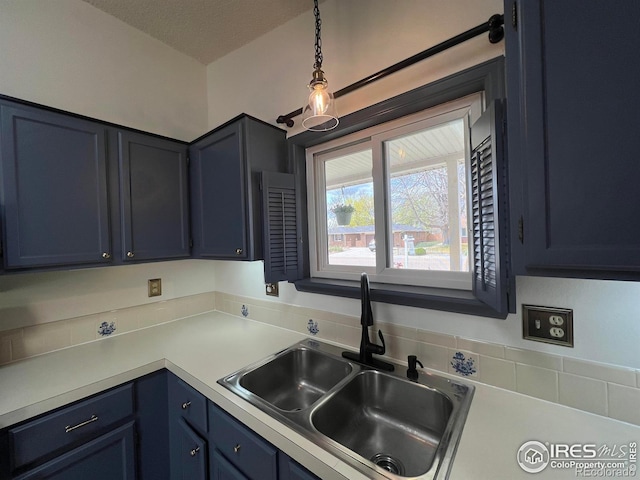 1406 Oak Dr, Berthoud, CO 80513 - kitchen featuring a sink, hanging light fixtures, light countertops, and blue cabinets