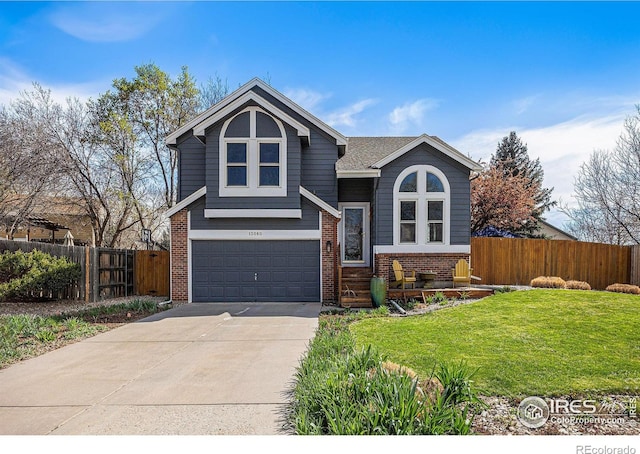 split level home with an attached garage, fence, concrete driveway, brick siding, and a front lawn
