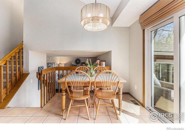 dining room with light tile patterned floors, plenty of natural light, visible vents, and stairs