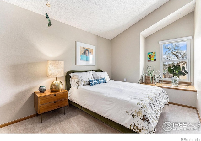 carpeted bedroom with a textured ceiling, baseboards, and vaulted ceiling