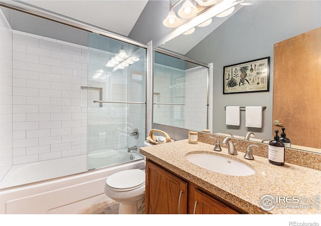 bathroom featuring shower / bath combination with glass door, vanity, and toilet