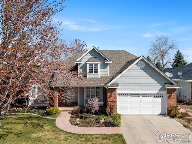 4748 Westbury Dr, Fort Collins, CO 80526 - view of front of home featuring a garage, roof with shingles, a front lawn, brick siding, and concrete driveway