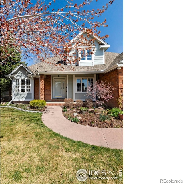 4748 Westbury Dr, Fort Collins, CO 80526 - view of front of property featuring brick siding, a front lawn, and roof with shingles