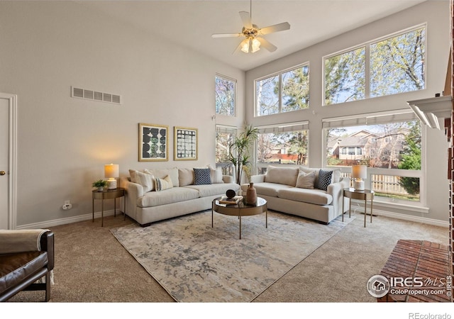 4748 Westbury Dr, Fort Collins, CO 80526 - carpeted living room featuring visible vents, a ceiling fan, plenty of natural light, and a high ceiling