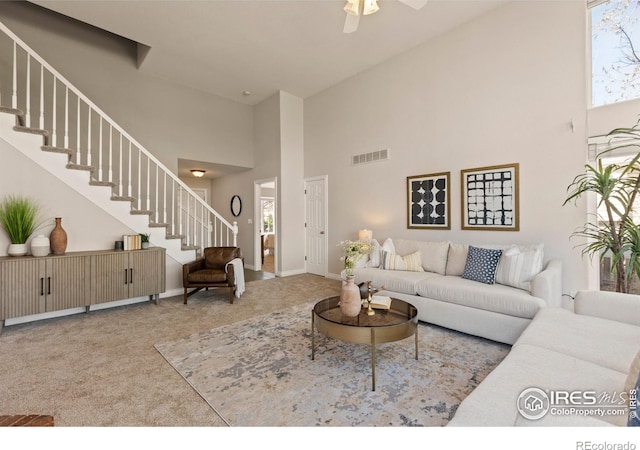 4748 Westbury Dr, Fort Collins, CO 80526 - carpeted living area with baseboards, a high ceiling, stairs, visible vents, and ceiling fan