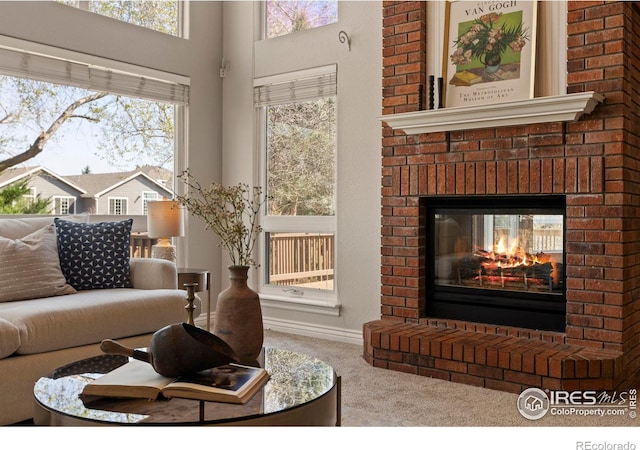 4748 Westbury Dr, Fort Collins, CO 80526 - living room featuring carpet floors, baseboards, a brick fireplace, and a healthy amount of sunlight