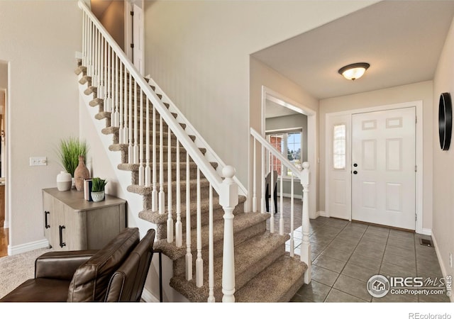 4748 Westbury Dr, Fort Collins, CO 80526 - foyer with tile patterned floors, baseboards, and stairway