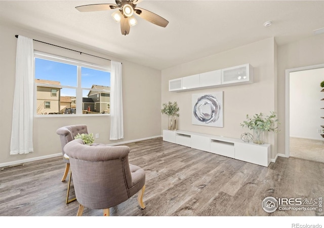 243 Gwyneth Lake Dr, Severance, CO 80550 - living area with ceiling fan, baseboards, wood finished floors, and visible vents