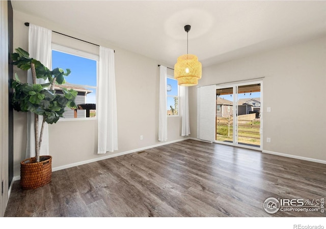 243 Gwyneth Lake Dr, Severance, CO 80550 - unfurnished dining area with baseboards and wood finished floors