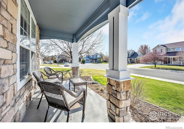 view of patio / terrace with a residential view and covered porch