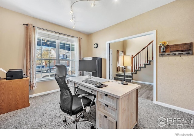 office featuring rail lighting, carpet, visible vents, and baseboards