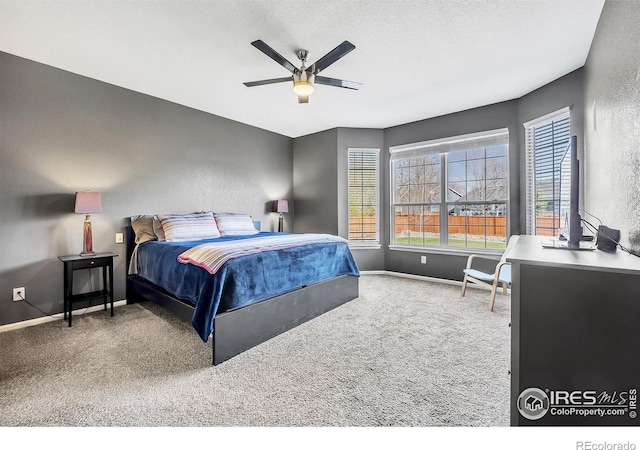 bedroom with ceiling fan, baseboards, and carpet floors