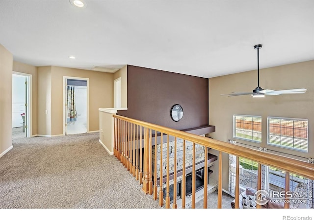 corridor with baseboards, an upstairs landing, carpet, and recessed lighting
