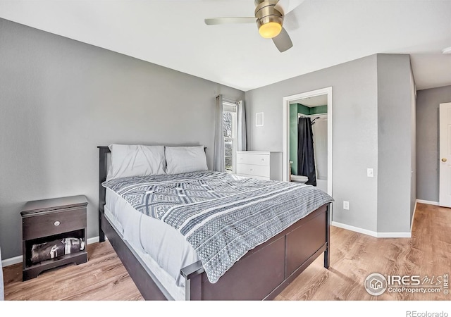 bedroom with a spacious closet, baseboards, a ceiling fan, and wood finished floors