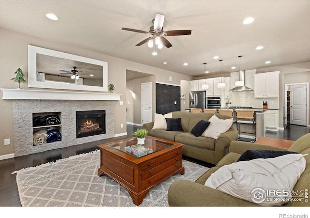 16848 Weber Way, Mead, CO 80542 - living area with a ceiling fan, recessed lighting, dark wood-type flooring, and a fireplace