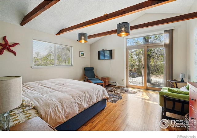 bedroom with lofted ceiling with beams, a textured ceiling, baseboard heating, wood-type flooring, and access to exterior