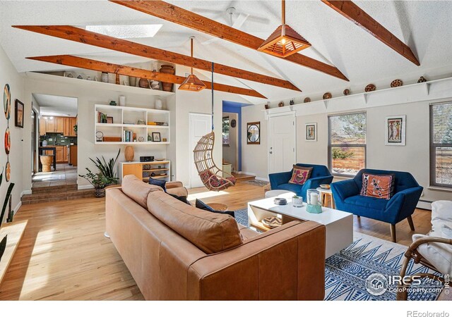living room with light wood-style flooring, lofted ceiling with beams, and baseboards