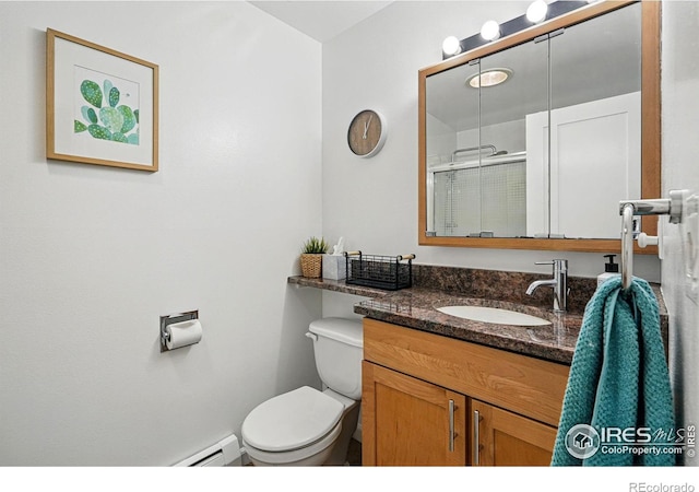 bathroom featuring toilet, a shower stall, vanity, and baseboard heating