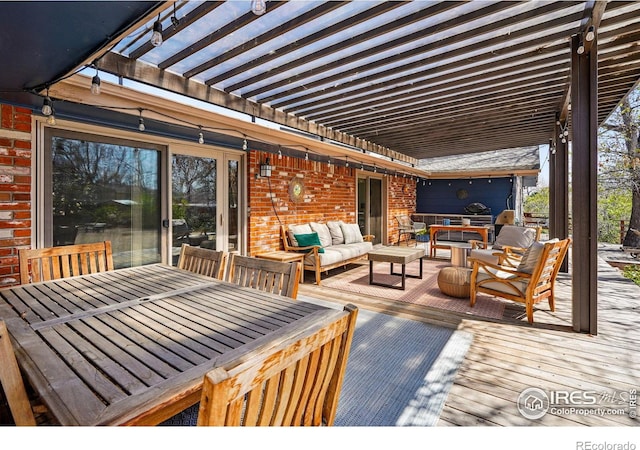 wooden deck featuring outdoor dining space, an outdoor hangout area, and a pergola
