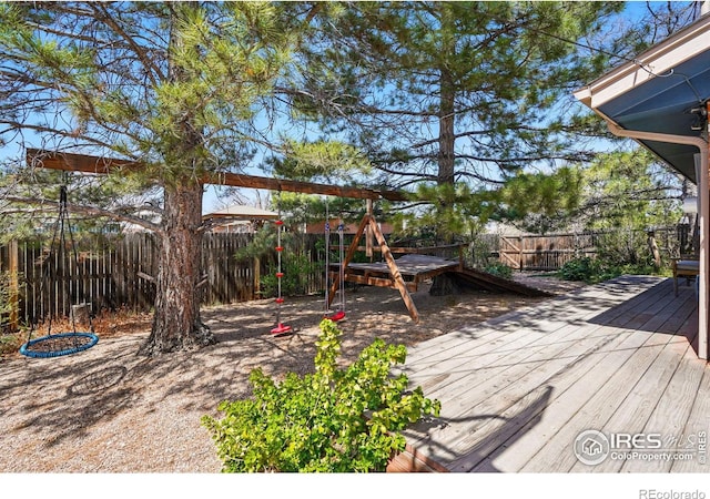 wooden terrace featuring a fenced backyard