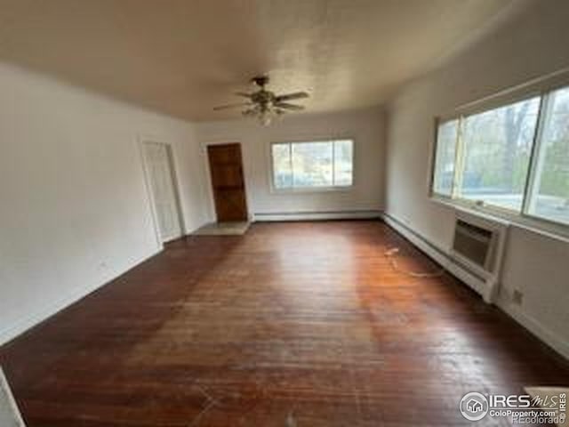 unfurnished living room with a healthy amount of sunlight, wood finished floors, baseboards, and a ceiling fan