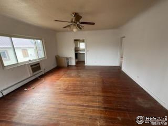 unfurnished living room with wood finished floors, ceiling fan, baseboards, and a baseboard heating unit