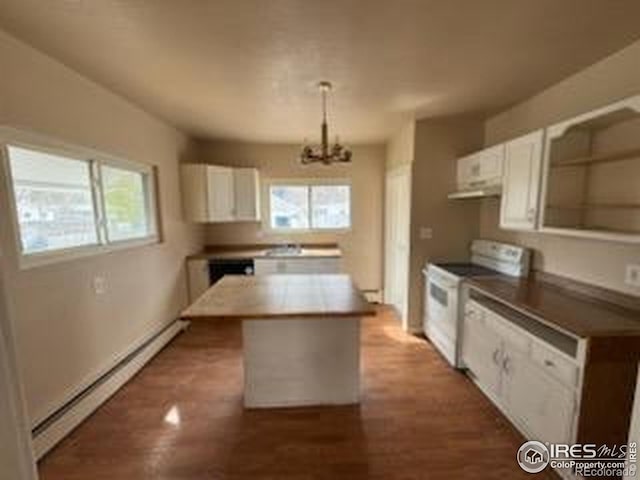 kitchen with white electric range oven, white cabinets, a notable chandelier, and baseboard heating